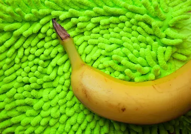 Conceptual color study of a banana on a lime green textured surface